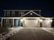 Two-story house with a gray exterior, white garage doors, and a concrete driveway at 251 Dyson Dr, Whiteland, IN 46184