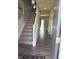 View into front door displays stairs, laminate floors, and an area rug at 251 Dyson Dr, Whiteland, IN 46184