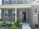 Gray home features front porch, gray brick, dark shutters, and a manicured lawn at 251 Dyson Dr, Whiteland, IN 46184