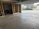 Open garage showing unfinished interior and view of the driveway and neighborhood at 251 Dyson Dr, Whiteland, IN 46184