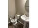 Bright half-bathroom with a round mirror and pedestal sink at 251 Dyson Dr, Whiteland, IN 46184