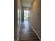 Inviting hallway with wood floors leads to the front door and offers a view of the outside at 251 Dyson Dr, Whiteland, IN 46184