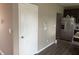 Hallway leads to an open-concept kitchen with stainless steel refrigerator, ample cabinet space, and wood floors at 251 Dyson Dr, Whiteland, IN 46184