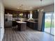 Modern kitchen featuring stainless steel appliances, center island, dark wood cabinets, and hardwood flooring at 251 Dyson Dr, Whiteland, IN 46184