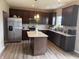 Beautiful kitchen with dark wood cabinets, stainless steel appliances, center island, and modern finishes at 251 Dyson Dr, Whiteland, IN 46184