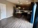 Stylish kitchen with a center island, stainless steel appliances, dark cabinets, and hardwood floors at 251 Dyson Dr, Whiteland, IN 46184