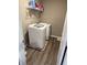 Laundry room with washer, dryer, shelving, and vinyl plank flooring at 251 Dyson Dr, Whiteland, IN 46184
