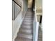 Carpeted stairway with white railings leading to the upper level at 251 Dyson Dr, Whiteland, IN 46184