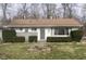 Charming ranch home with gray siding, landscaping, and a small bridge at 2610 W 18Th St, Anderson, IN 46011