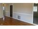 Hardwood floors and neutral walls in this spacious living room at 2610 W 18Th St, Anderson, IN 46011