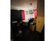 Cozy bedroom with double bed, dark headboard, and red curtains at 2615 Baltimore Ave, Indianapolis, IN 46218