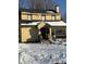 Cute yellow house with snow covered yard at 2615 Baltimore Ave, Indianapolis, IN 46218