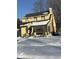 Snow covered yard and charming yellow house at 2615 Baltimore Ave, Indianapolis, IN 46218