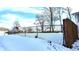 Snow-covered yard with chain link fence and wooden gate at 2815 E 23Rd St, Indianapolis, IN 46218