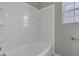 White tiled bathtub and shower with built-in shelves at 297 Van Buren St, Greenfield, IN 46140