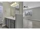 Modern bathroom with gray vanity, large mirror, and window for natural light at 297 Van Buren St, Greenfield, IN 46140