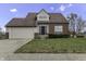 Brick house with two-car garage and manicured lawn at 297 Van Buren St, Greenfield, IN 46140