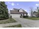Two-story house with a brick and vinyl exterior, attached garage, and a landscaped yard at 297 Van Buren St, Greenfield, IN 46140