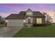 Brick house with attached garage, landscaping, and a well-maintained lawn at 297 Van Buren St, Greenfield, IN 46140
