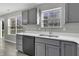 Gray kitchen cabinets, stainless steel appliances, and white countertops at 297 Van Buren St, Greenfield, IN 46140