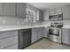 Modern kitchen featuring gray cabinets and stainless steel appliances at 297 Van Buren St, Greenfield, IN 46140