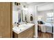 Modern bathroom with double vanity and view of bedroom at 3015 Olive Branch Rd, Greenwood, IN 46143