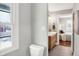 Updated bathroom with floating vanity and a view into bedroom at 3015 Olive Branch Rd, Greenwood, IN 46143
