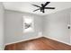 Well-lit bedroom featuring hardwood floors and ceiling fan at 3015 Olive Branch Rd, Greenwood, IN 46143