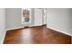 Well-lit bedroom featuring hardwood floors and a window with street view at 3015 Olive Branch Rd, Greenwood, IN 46143