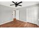 Bedroom with hardwood floors, ceiling fan and access to another room at 3015 Olive Branch Rd, Greenwood, IN 46143