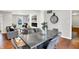 Modern dining room with a large metal table and six chairs, hardwood floors and fireplace at 3015 Olive Branch Rd, Greenwood, IN 46143
