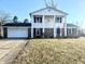 Traditional two-story home featuring a symmetrical facade, white siding, brick accents, and a two-car garage at 3015 Olive Branch Rd, Greenwood, IN 46143
