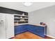 Eat-in kitchen with blue cabinets, butcher block countertops, and floating shelves at 3015 Olive Branch Rd, Greenwood, IN 46143