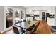 Modern kitchen with white cabinets, dark blue tile backsplash, and hardwood floors at 3015 Olive Branch Rd, Greenwood, IN 46143