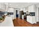 Modern kitchen with white cabinets, stainless steel appliances, and hardwood floors at 3015 Olive Branch Rd, Greenwood, IN 46143