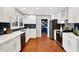 Modern kitchen with white cabinets, stainless steel appliances, and hardwood floors at 3015 Olive Branch Rd, Greenwood, IN 46143