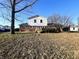 Exterior rear view of a two-story home with a brick and white siding facade and a spacious backyard at 3015 Olive Branch Rd, Greenwood, IN 46143