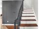 Elegant staircase with dark wood steps and black railing at 3015 Olive Branch Rd, Greenwood, IN 46143