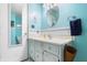 Light blue bathroom with white vanity and fixtures at 3055 Davis Rd, Indianapolis, IN 46239