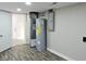 Unfinished basement with water heater, HVAC unit, and electrical panel at 3153 N Layman Ave, Indianapolis, IN 46218