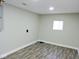Finished basement room with new flooring and a window for natural light at 3153 N Layman Ave, Indianapolis, IN 46218