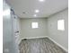Finished basement room with vinyl flooring and windows at 3153 N Layman Ave, Indianapolis, IN 46218