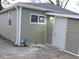 View of the house showcasing the exterior door, window, and siding with gas meter at 3153 N Layman Ave, Indianapolis, IN 46218