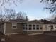Rear view of home featuring green siding and a sunroom with bright, natural light at 3153 N Layman Ave, Indianapolis, IN 46218