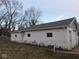The detached garage needs painting and repair along its cinder block at 3153 N Layman Ave, Indianapolis, IN 46218