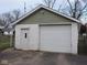 The detached garage is made of white cinder block with a white door and trim at 3153 N Layman Ave, Indianapolis, IN 46218