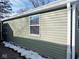 Side view of house with green vinyl siding and a window at 3153 N Layman Ave, Indianapolis, IN 46218