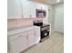 Modern kitchen with white cabinets and marble counters at 3153 N Layman Ave, Indianapolis, IN 46218