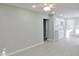 Spacious living room with ceiling fan and grey floors at 3153 N Layman Ave, Indianapolis, IN 46218