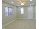 Living room with ceiling fan, grey floor, and white door at 3153 N Layman Ave, Indianapolis, IN 46218